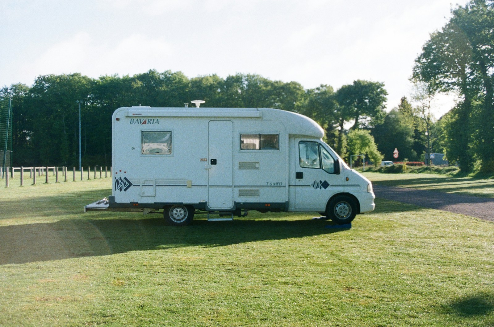 white and blue van on green grass field during daytime, RV